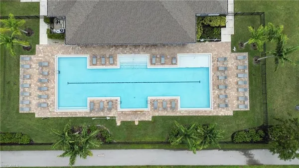 a aerial view of a house with a lake and a swimming pool