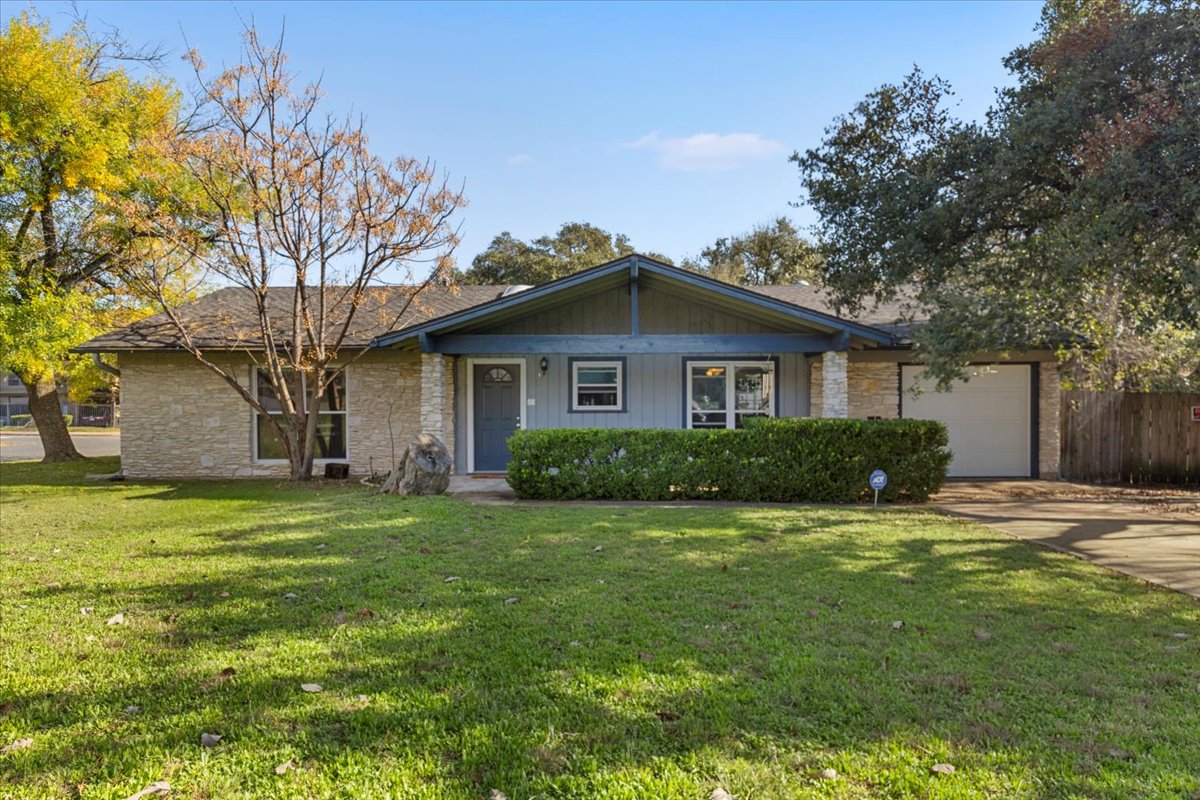 8713 Azalea Trail Austin, TX 78759 - Photo 1 of 13 A welcoming front exterior with stone accents and a well-maintained lawn.