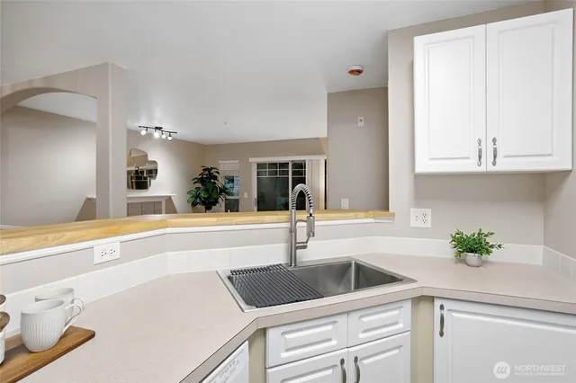 a kitchen with white cabinets and white appliances