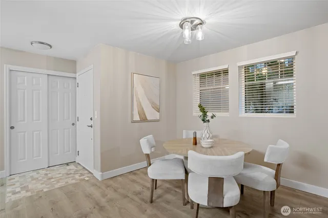a bedroom with a bed lamp and a potted plant