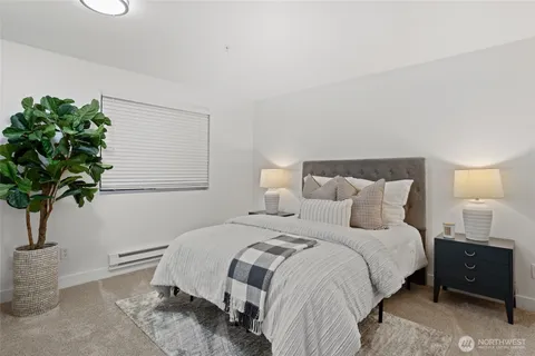 a bedroom with a bed and a lamp