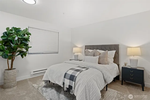 a bedroom with a bed and a lamp