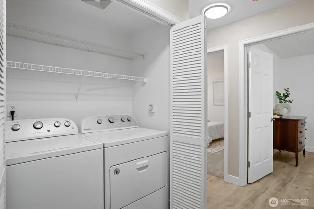 a bathroom with a toilet a sink a glass door a shower and mirror