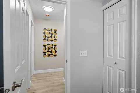 a living room with a chair and a wooden floor