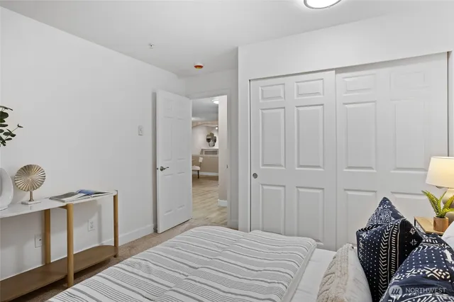 a living room with furniture a potted plant and a fireplace