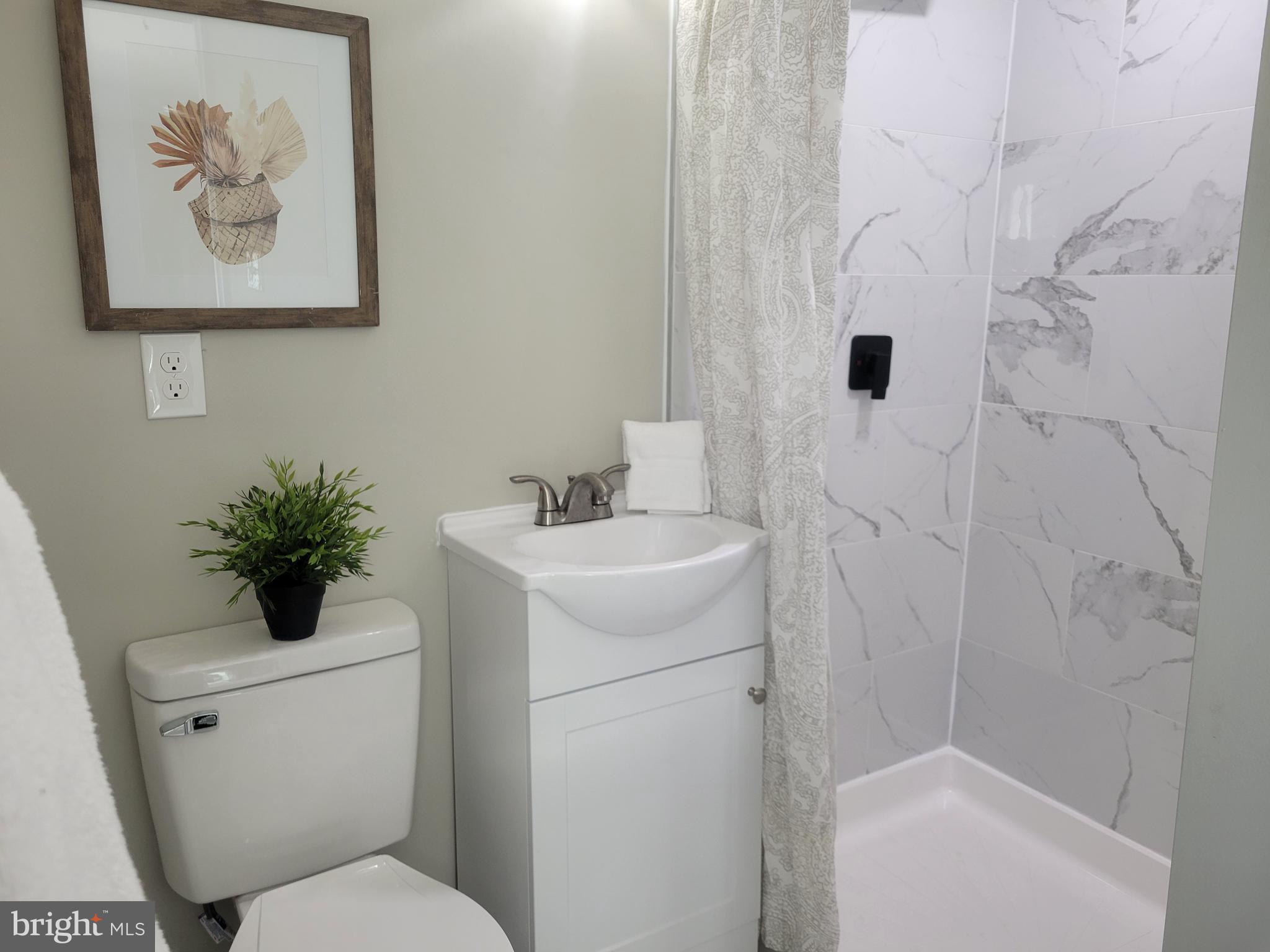 5303 Emory Road Upperco, MD 21155 - Photo 16 of 33 a bathroom with a toilet sink and vanity