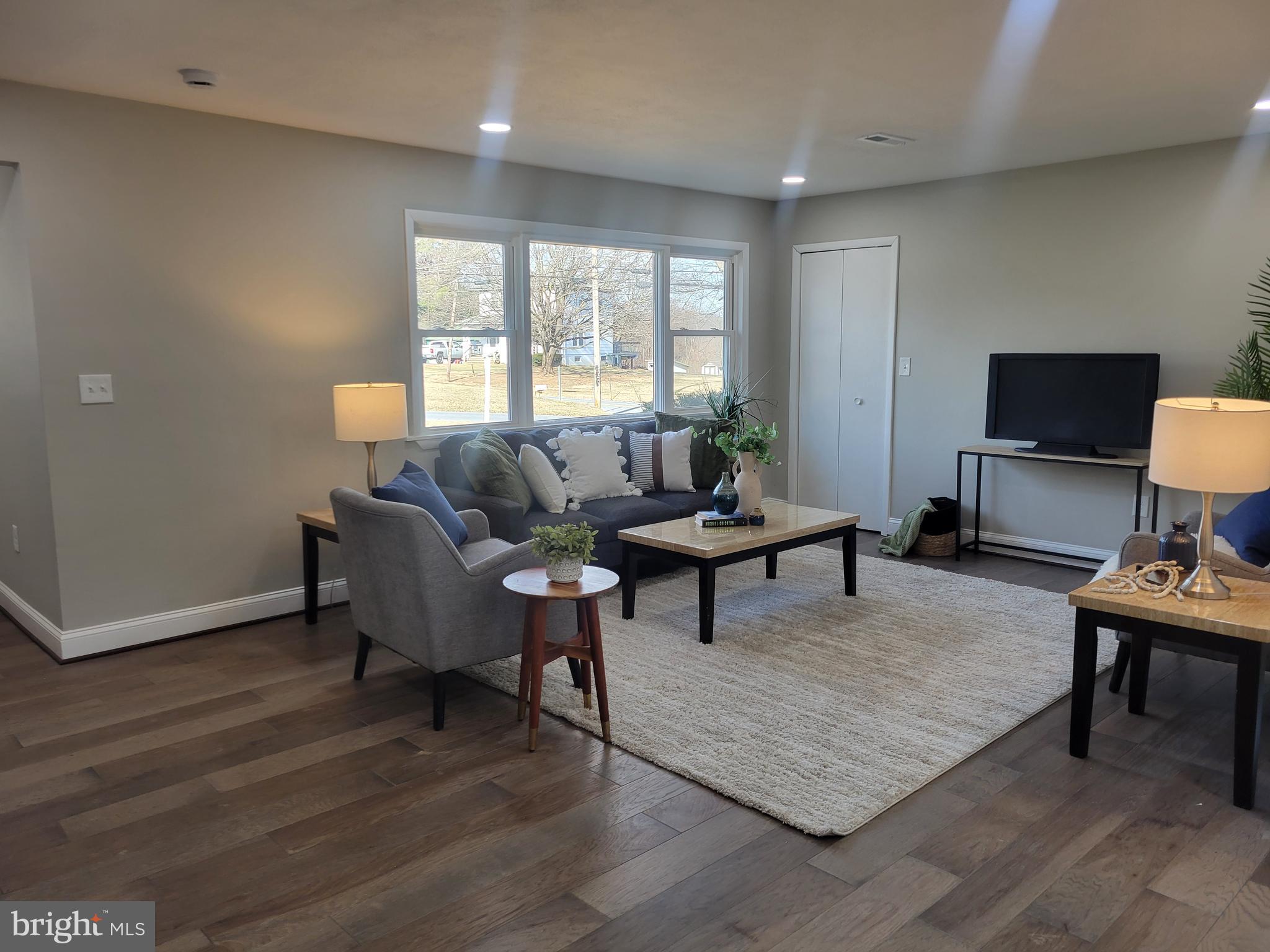 5303 Emory Road Upperco, MD 21155 - Photo 2 of 33 a living room with furniture a rug a lamp and a window