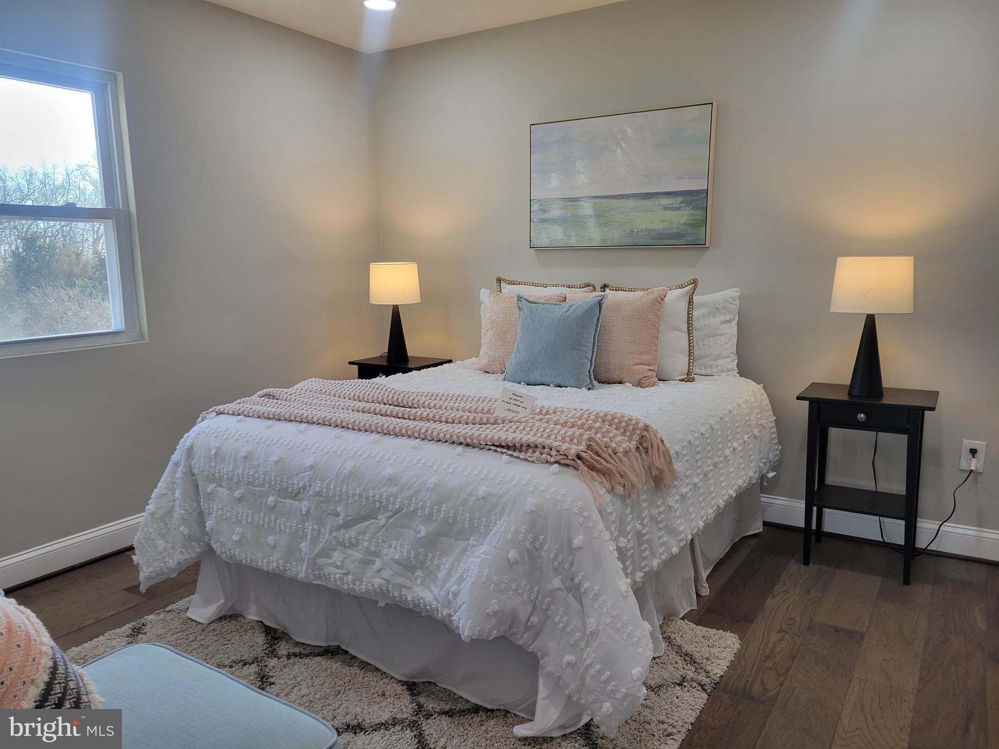 5303 Emory Road Upperco, MD 21155 - Photo 7 of 33 a bedroom with a bed and a lamp next to a window