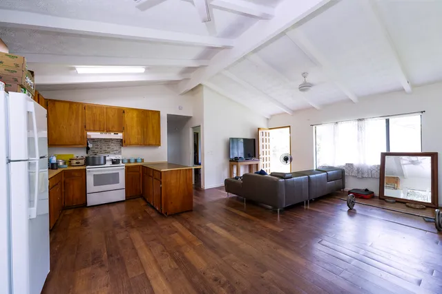a kitchen with living room cabinets and wooden floor