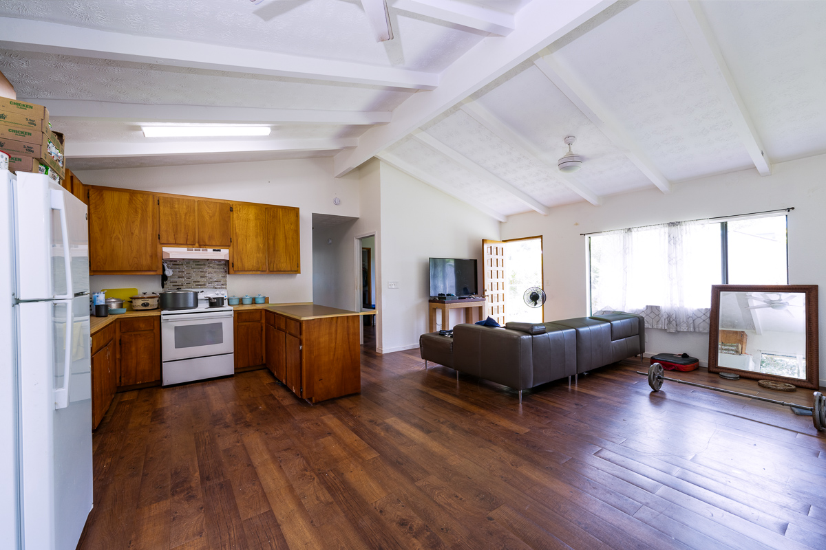 15-2808 Moi Street Pahoa, HI 96778 - Photo 2 of 11 a kitchen with living room cabinets and wooden floor