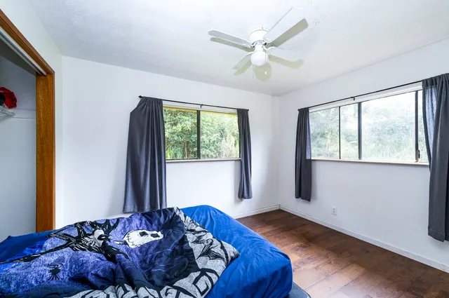a bedroom with a large bed and a window