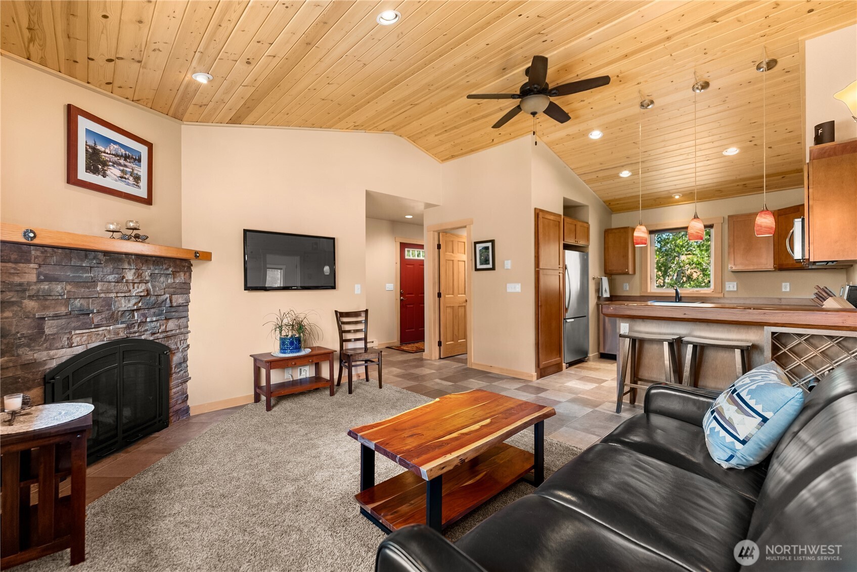 130 Sundown Road Winthrop, WA 98862 - Photo 32 of 40 a living room with furniture a flat screen tv and a fireplace