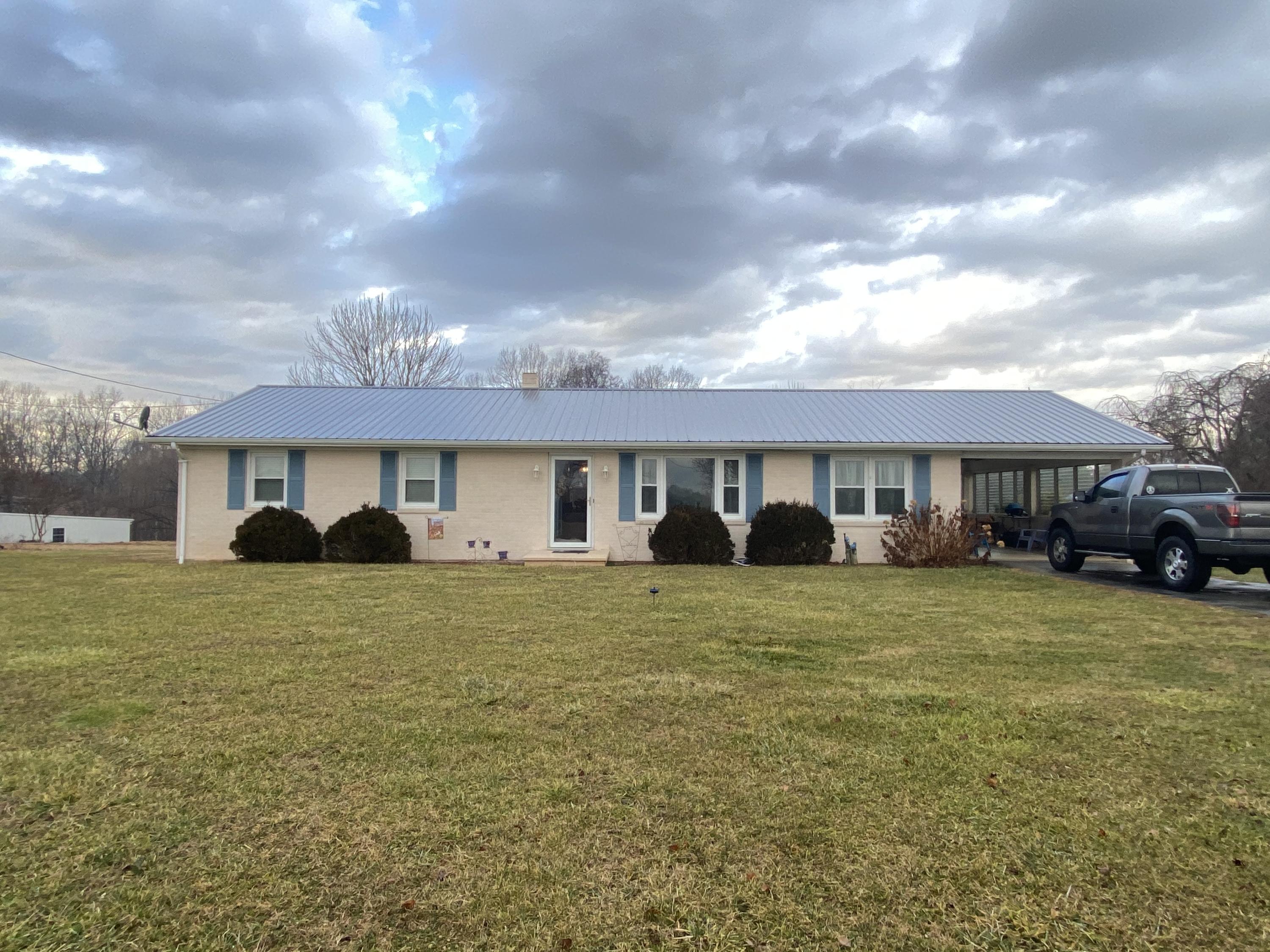 1171 Rock Spring Road Goodview, VA 24095 - Photo 1 of 29 a front view of a house with a yard