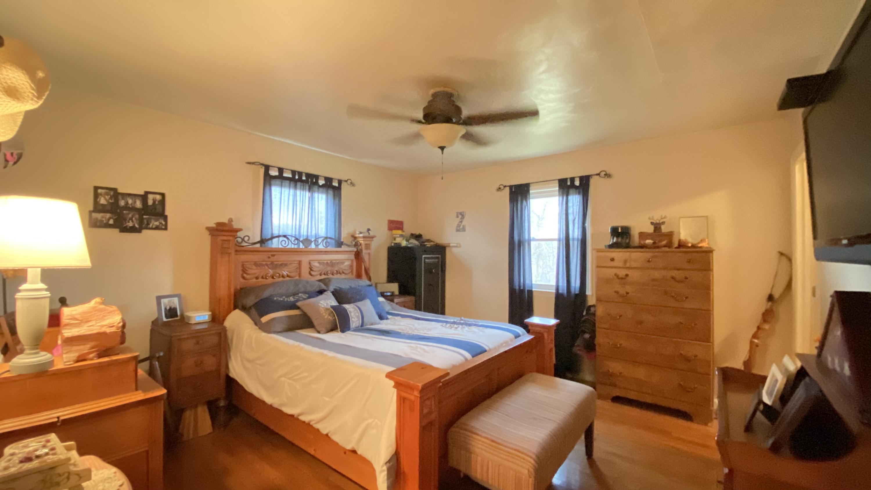 1171 Rock Spring Road Goodview, VA 24095 - Photo 17 of 29 a bedroom with a bed and wooden floor
