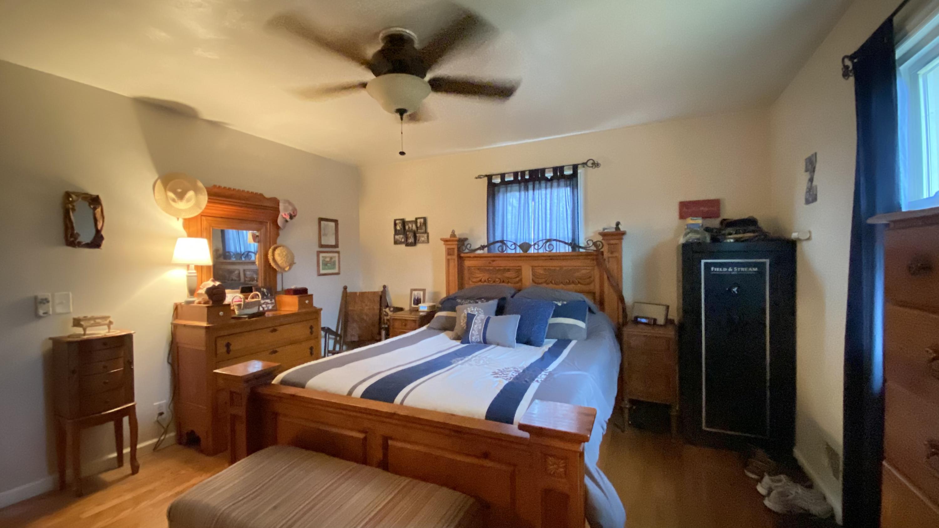 1171 Rock Spring Road Goodview, VA 24095 - Photo 18 of 29 a bed room with a bed and a ceiling fan