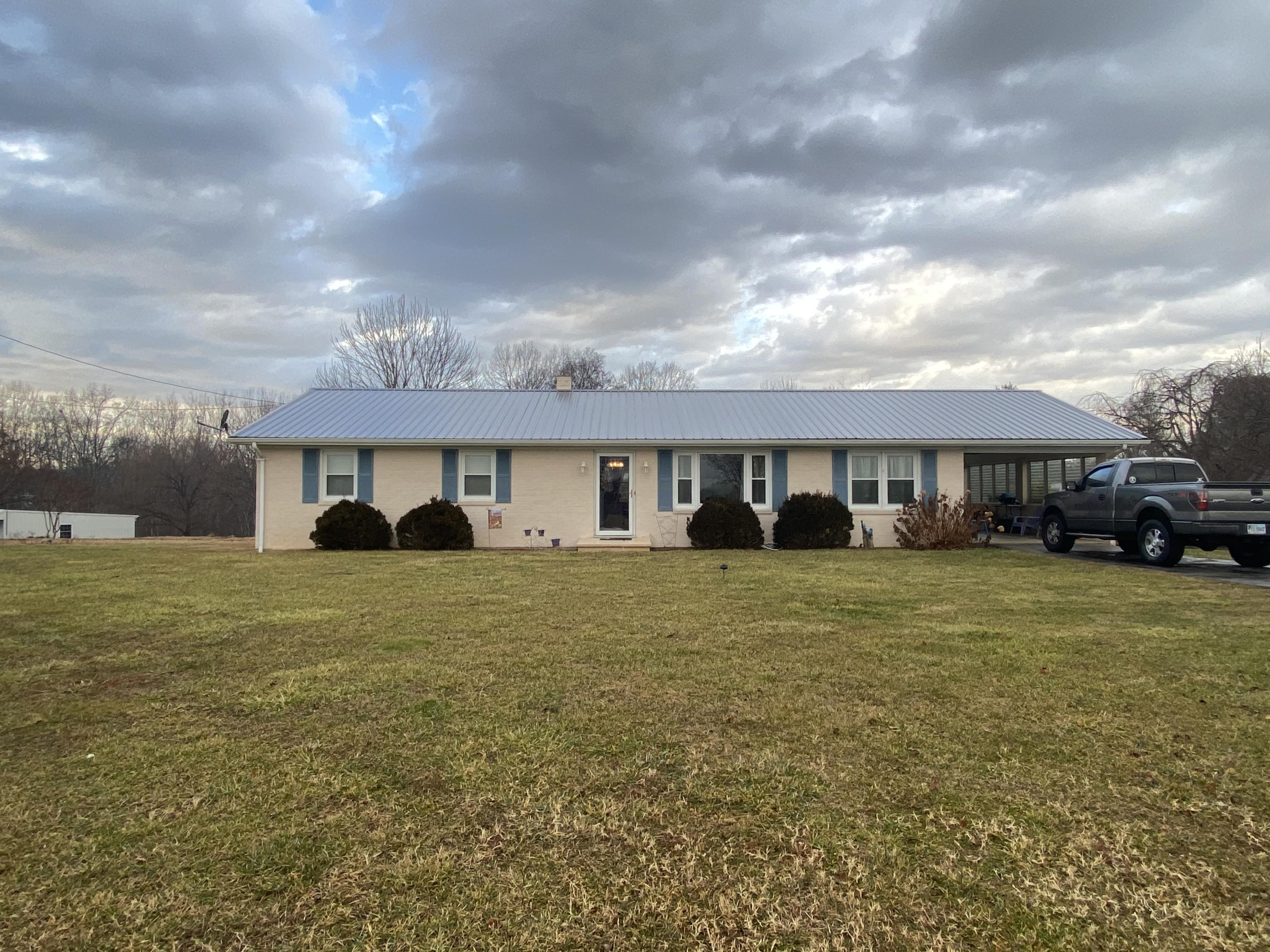 1171 Rock Spring Road Goodview, VA 24095 - Photo 3 of 29 a front view of a house with a yard and garage