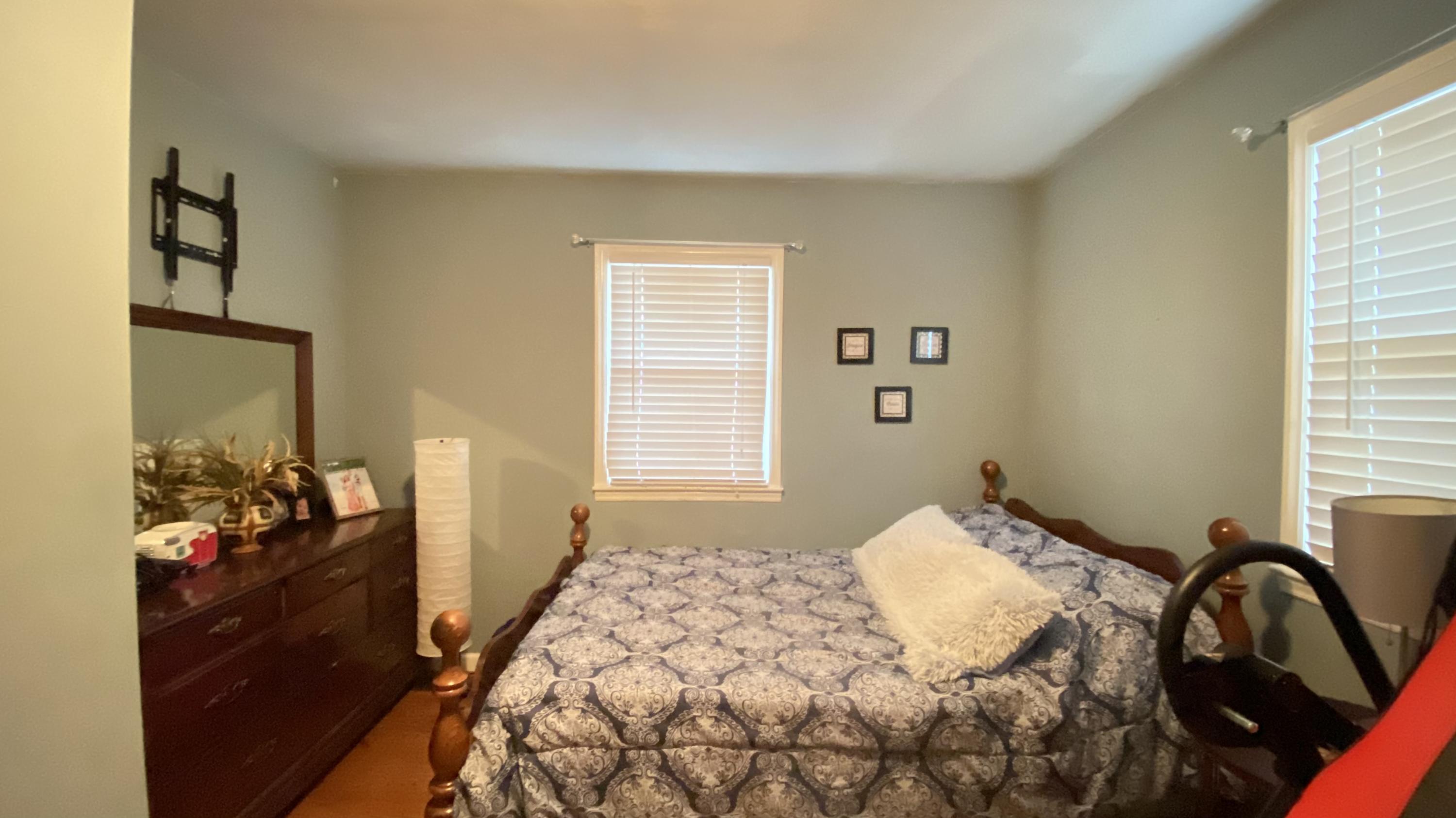 1171 Rock Spring Road Goodview, VA 24095 - Photo 22 of 29 a bedroom with a bed and dresser with mirror