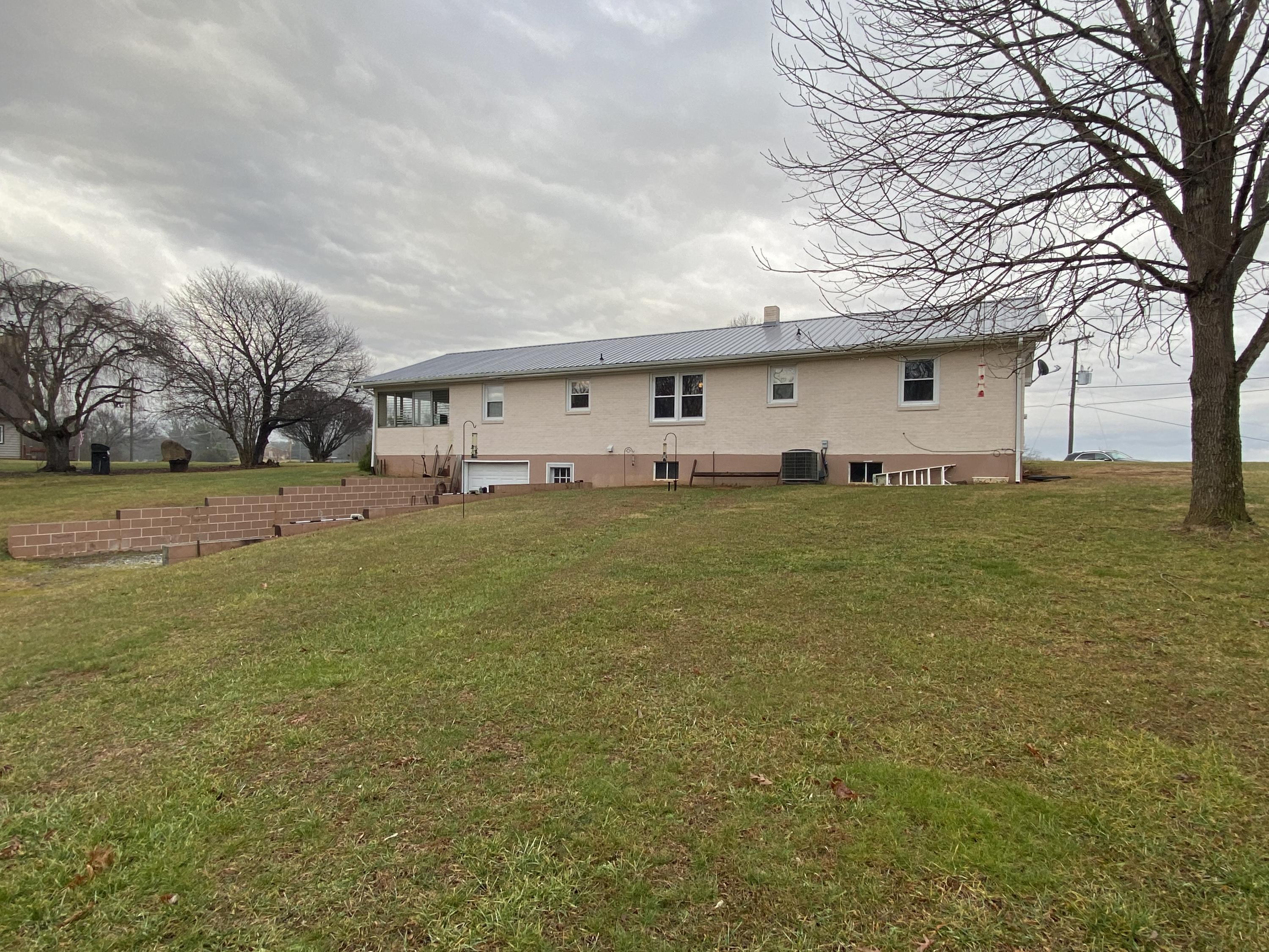 1171 Rock Spring Road Goodview, VA 24095 - Photo 25 of 29 a big white house with a large tree in front of it