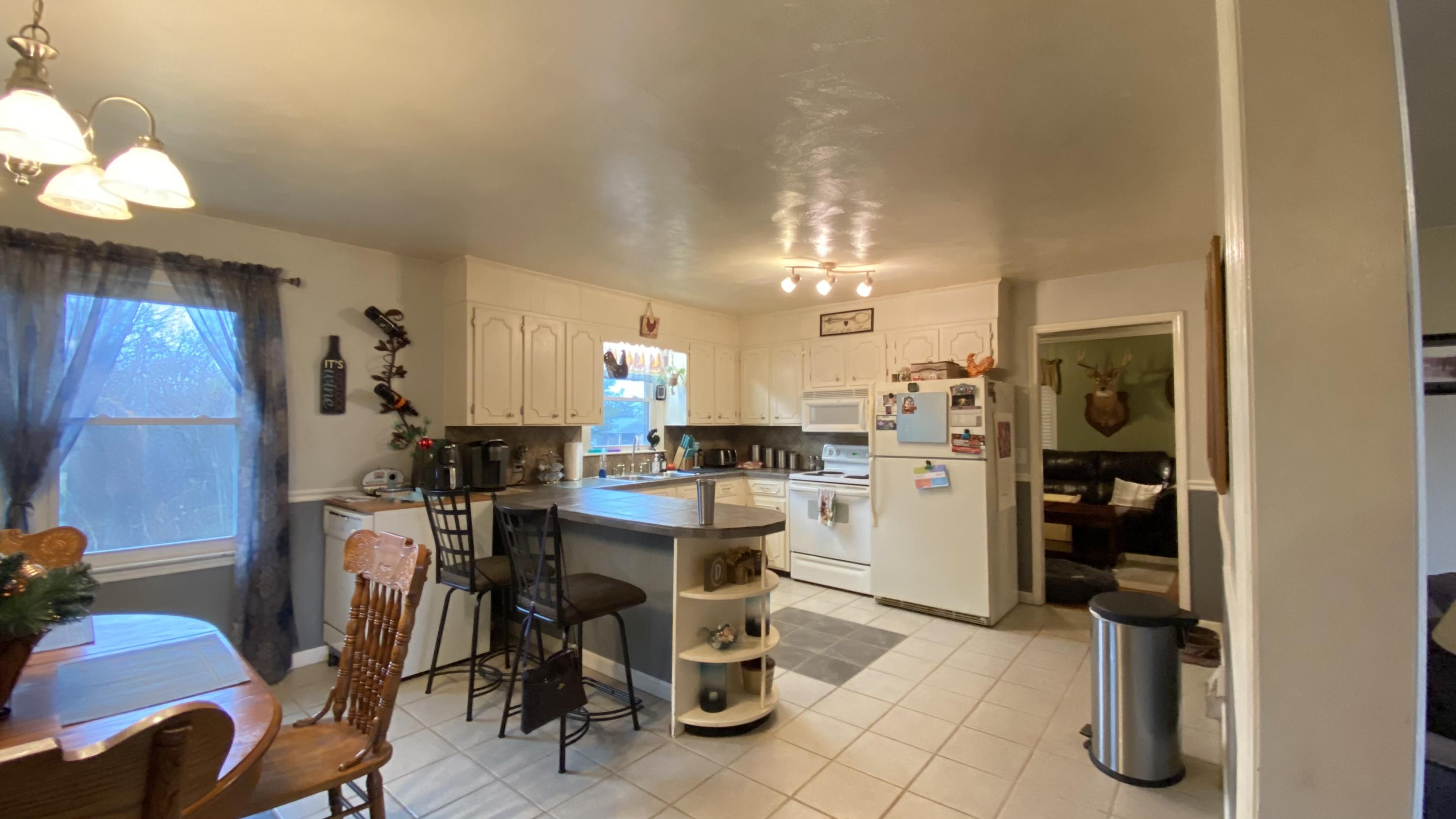 1171 Rock Spring Road Goodview, VA 24095 - Photo 9 of 29 a kitchen with a sink dishwasher a refrigerator and cabinets