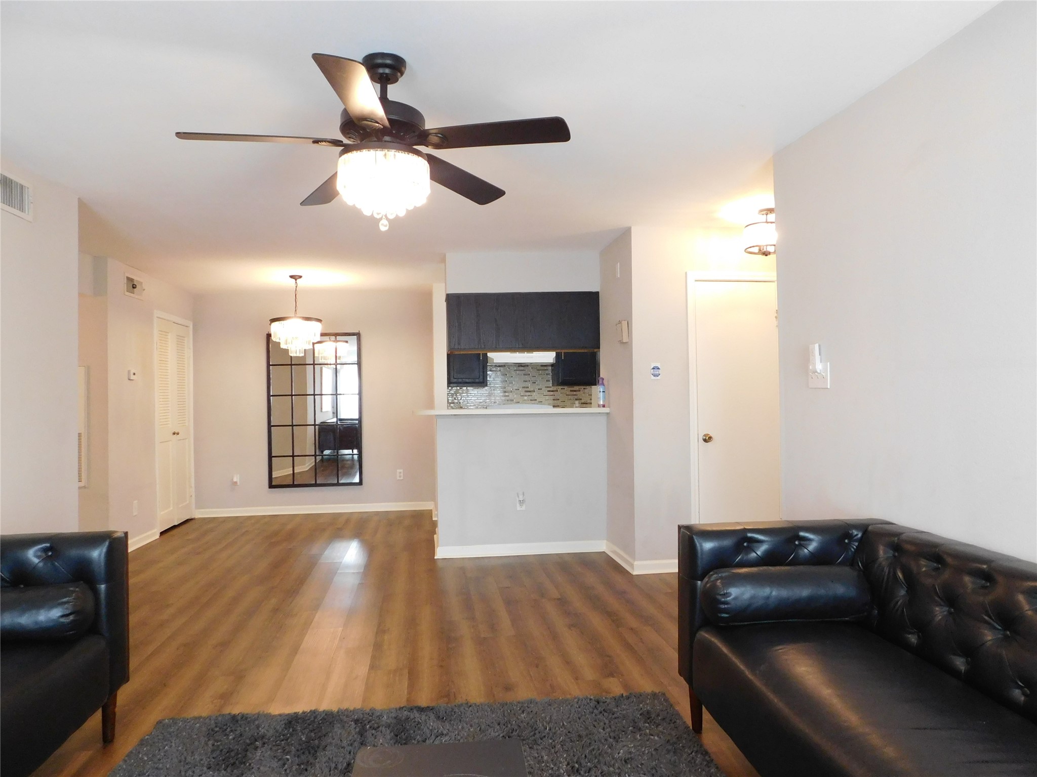 10101 South Gessner Road, Unit 912 Houston, TX 77071 - Photo 4 of 47 a living room with furniture and a wooden floor