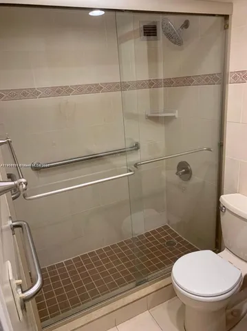 a bathroom with a toilet and a shower