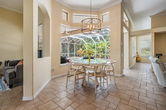 a dining room filled with furniture and a chandelier