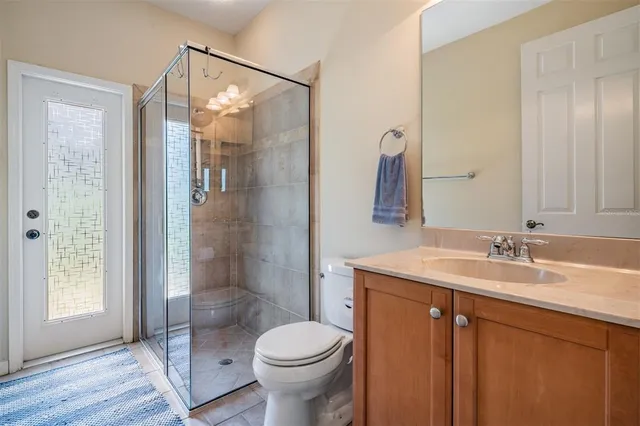 a bathroom with a granite countertop sink toilet and shower