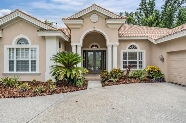 a view of a brick house with potted plants