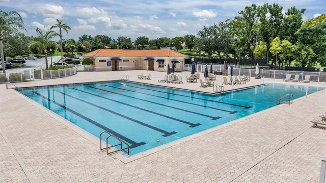 an aerial view of house with outdoor space swimming pool and lake view