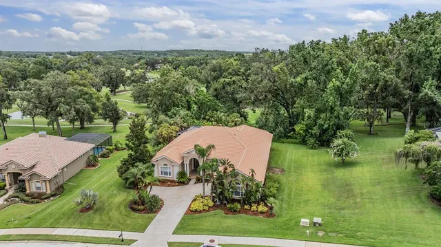 an aerial view of a house with a yard