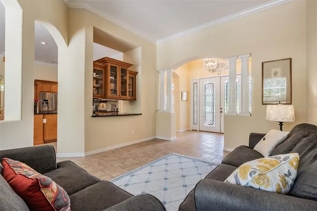 a living room with furniture and painting on the wall