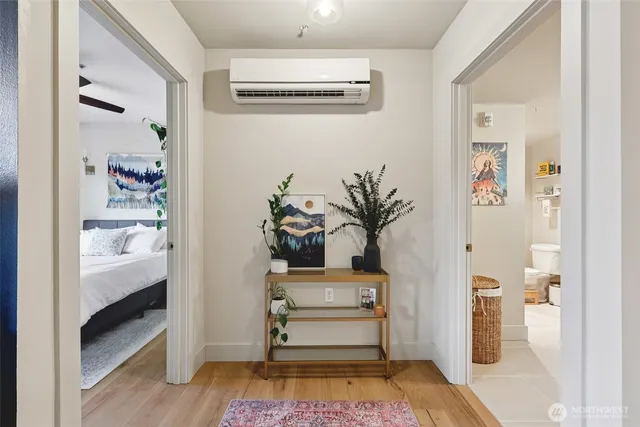 a room with painting and a potted plant