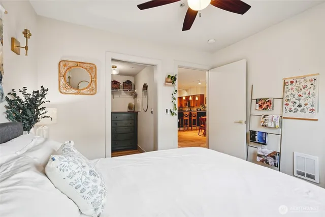 a bedroom with bed and wooden floor