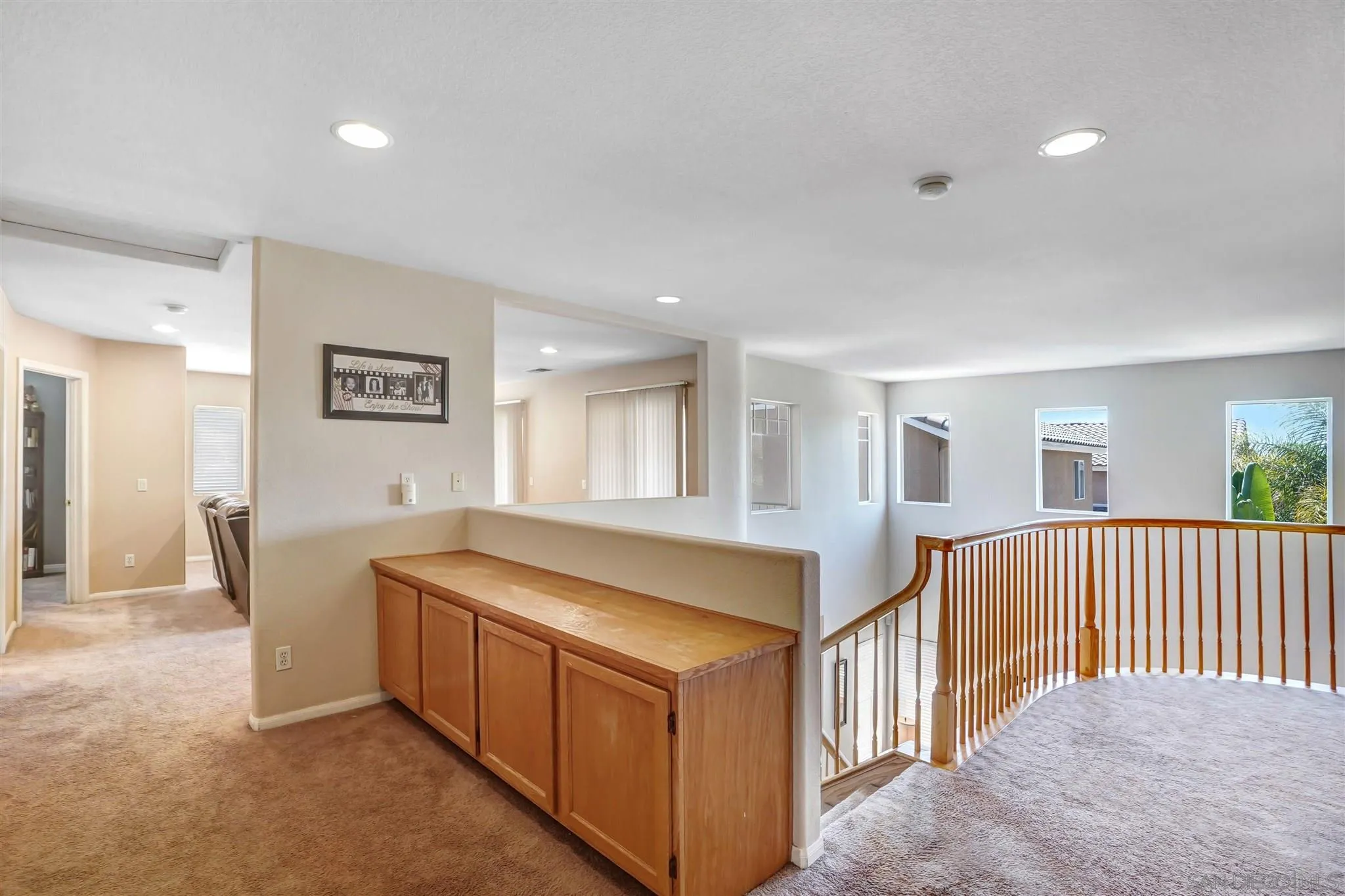 1266 Riviera Summit Road San Diego, CA 92154 - Photo 17 of 41 a living room with a balcony a bed and a cabinets