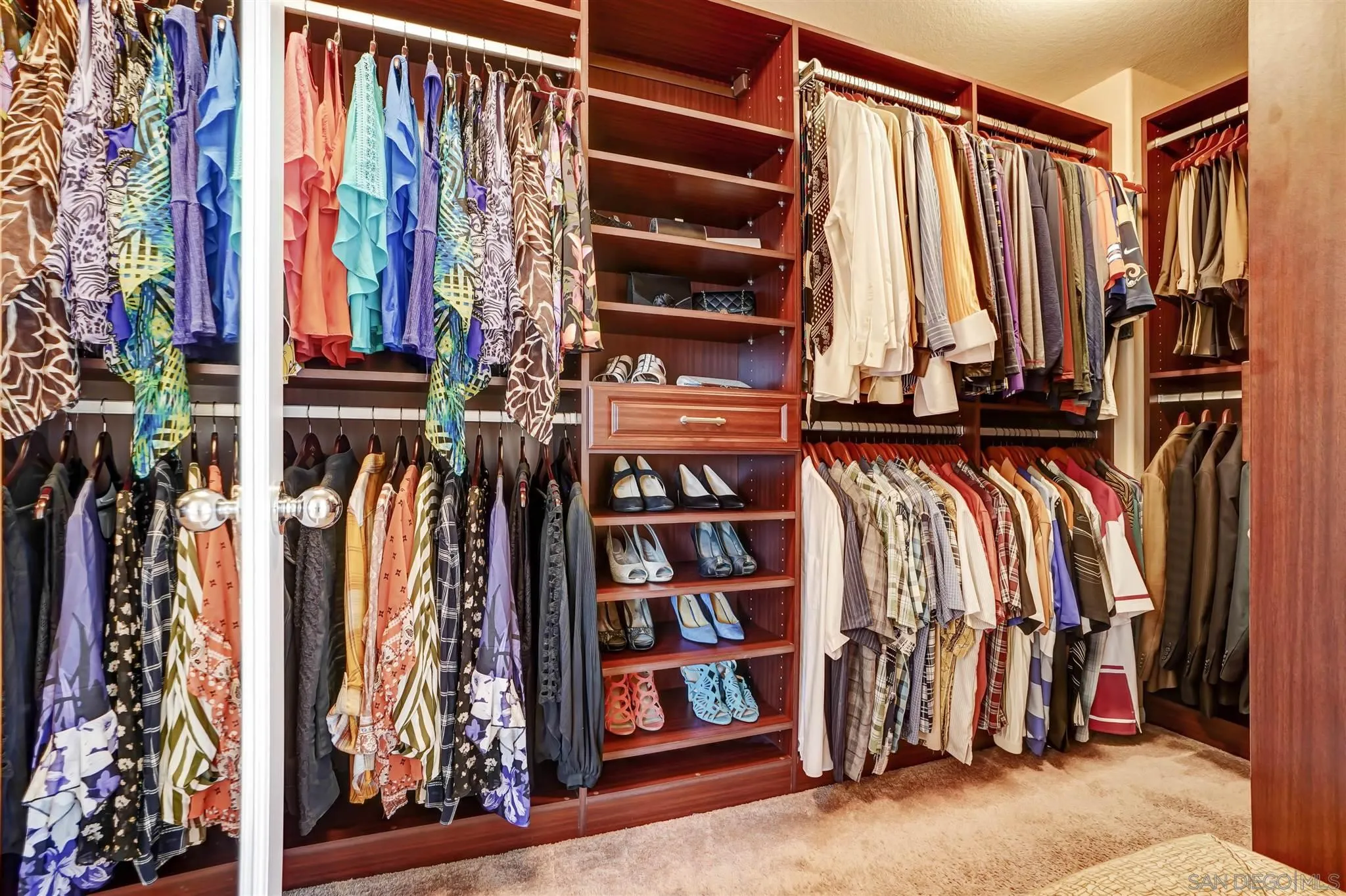 1266 Riviera Summit Road San Diego, CA 92154 - Photo 26 of 41 a view of walk in closet with clothes and shoes