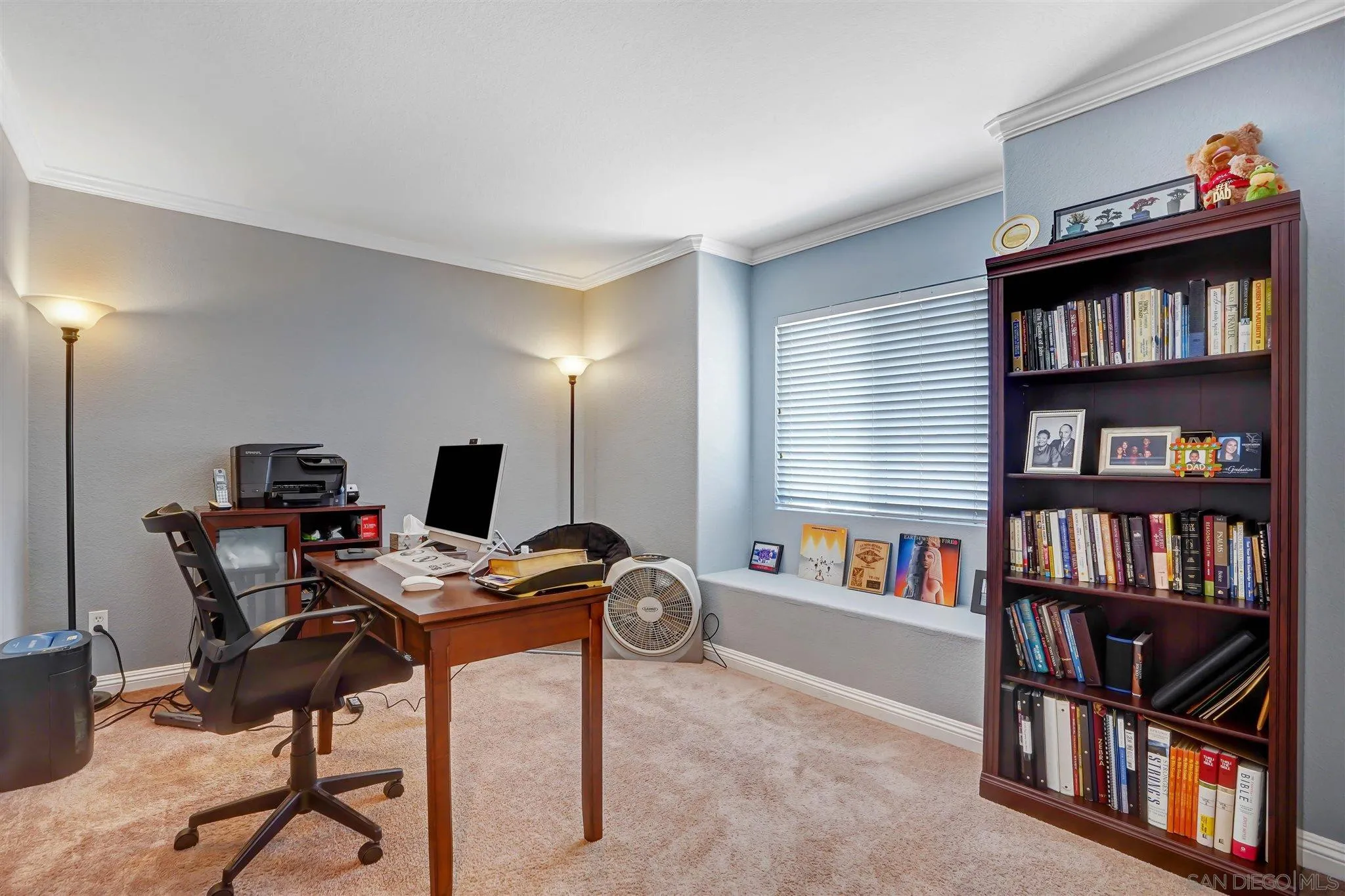 1266 Riviera Summit Road San Diego, CA 92154 - Photo 29 of 41 a workspace with a bookshelf and a desk