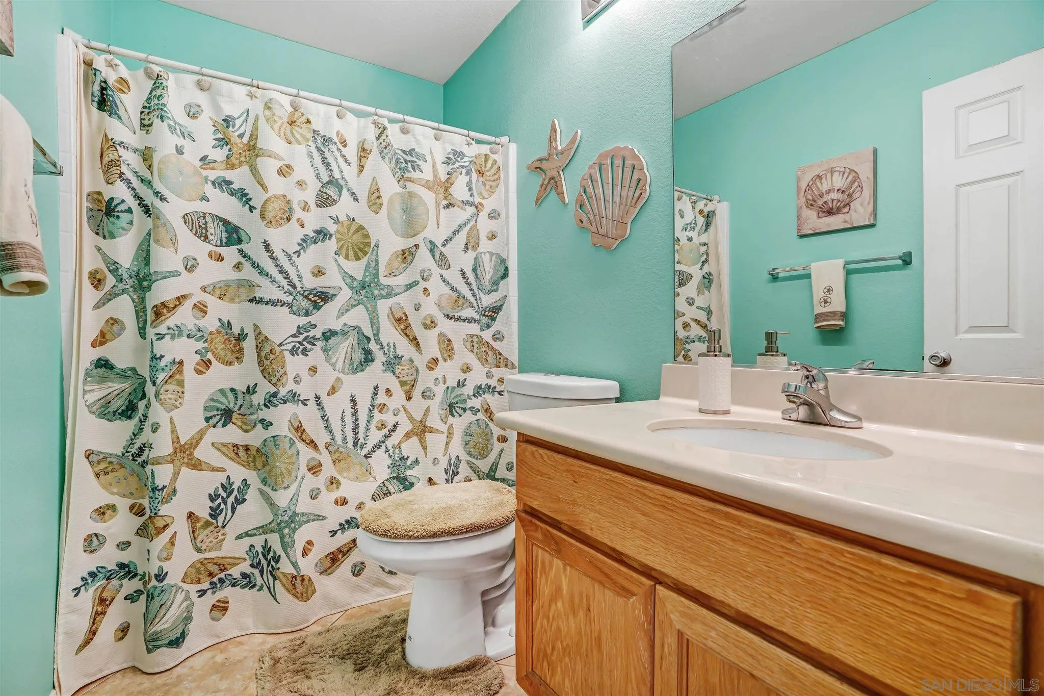 1266 Riviera Summit Road San Diego, CA 92154 - Photo 33 of 41 a bathroom with a sink and a mirror