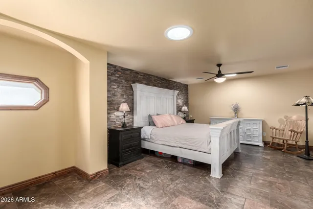 a bedroom with a bed and a chandelier