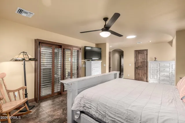 a bedroom with a large bed and a large window