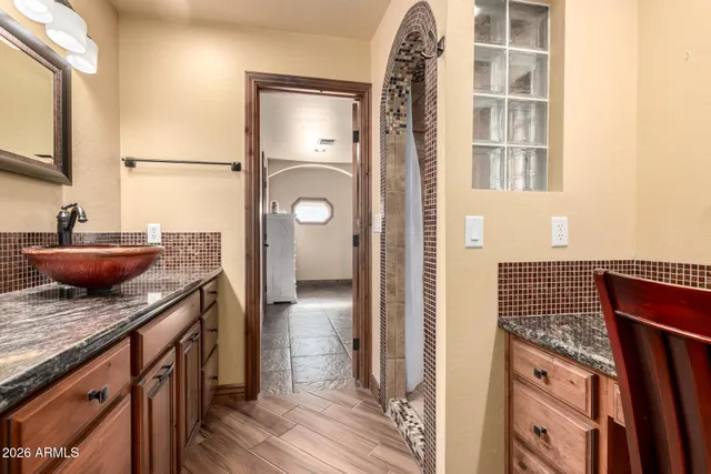 a kitchen with stainless steel appliances granite countertop a sink and a stove