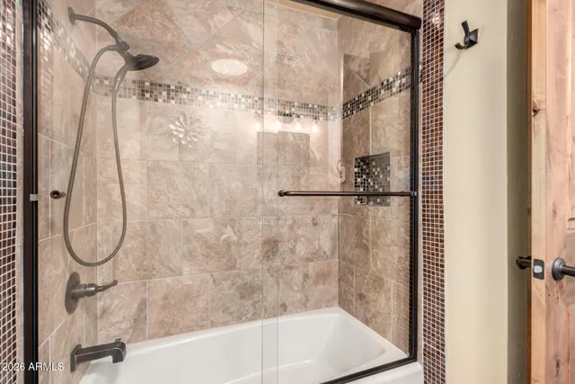 a bathroom with a shower and a bath tub