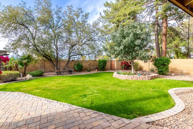 a backyard of a house with table and chairs