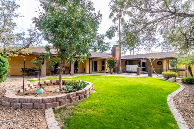 a front view of a house with swimming pool having outdoor seating