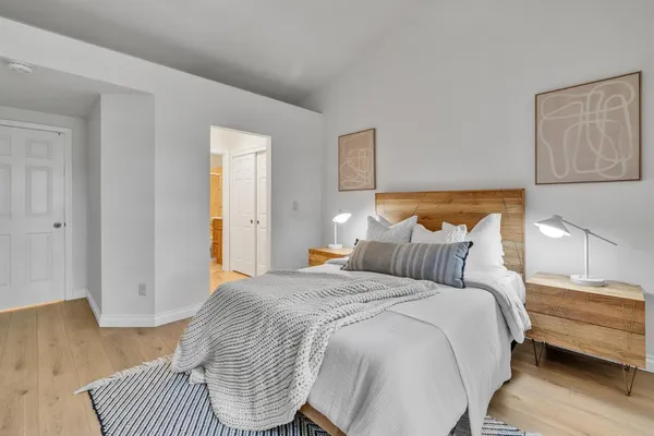 a bedroom with a bed and a lamp