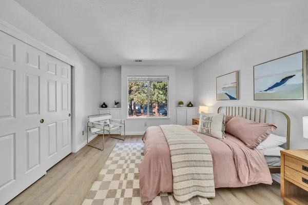 a bed sitting in a bedroom next to a window