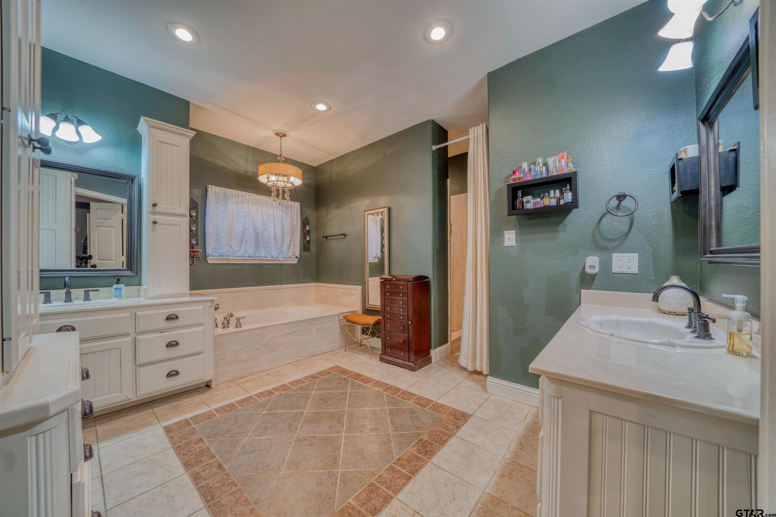 1776 Mustang Road Gilmer, TX 75645 - Photo 33 of 45 a spacious bathroom with a sink double vanity granite and a mirror