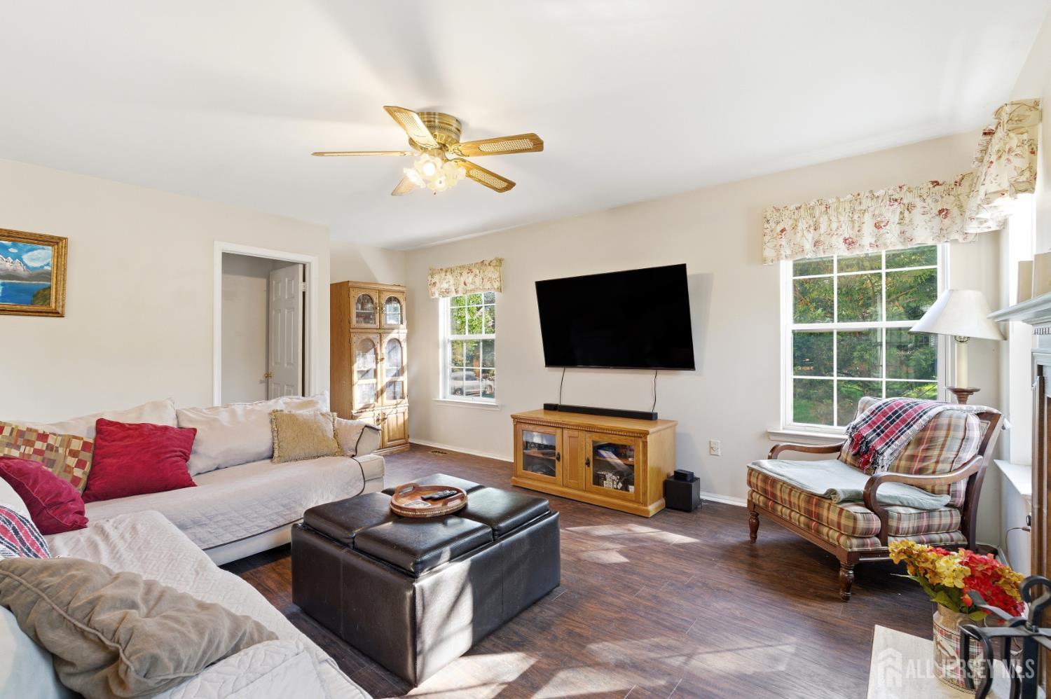 6 Shoshoni Way Somerville, NJ 08876 - Photo 15 of 52 a living room with furniture a flat screen tv and a large window