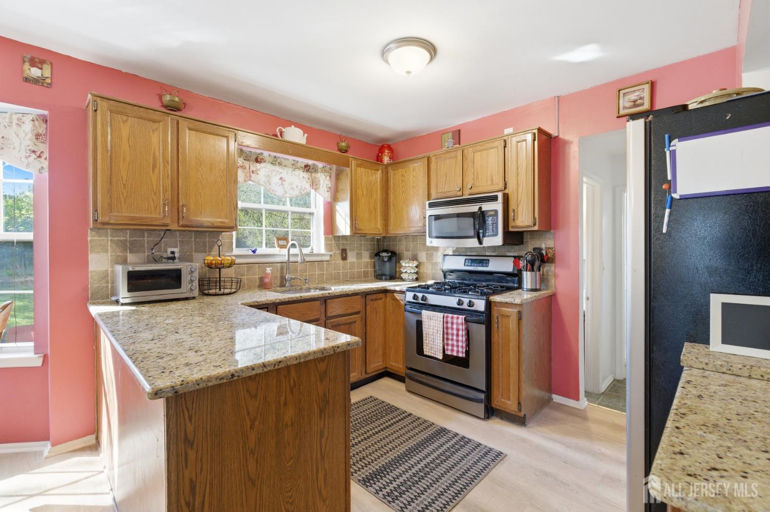 6 Shoshoni Way Somerville, NJ 08876 - Photo 20 of 52 a kitchen with stainless steel appliances granite countertop a stove top oven a sink dishwasher and a refrigerator with wooden floor