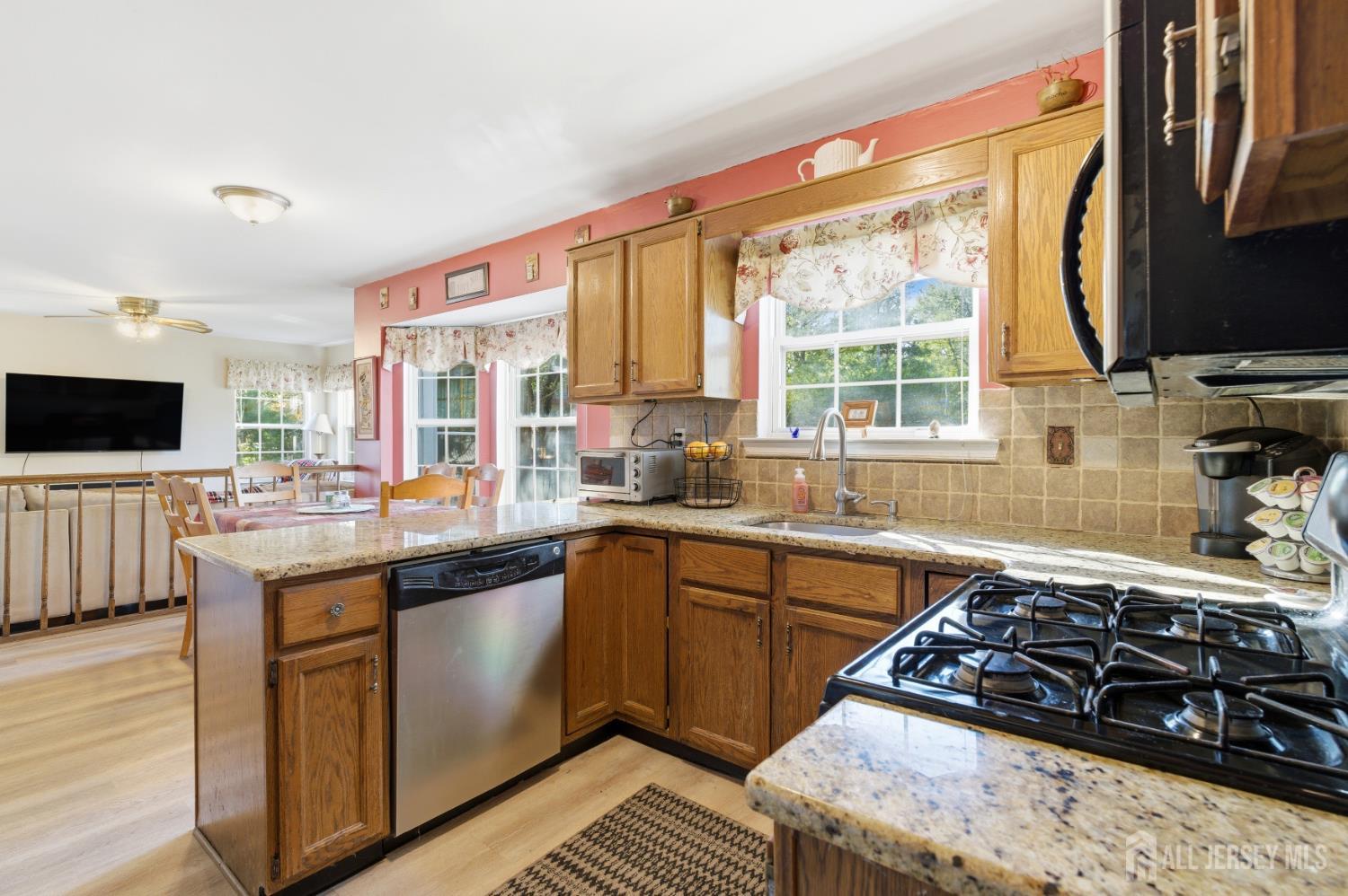 6 Shoshoni Way Somerville, NJ 08876 - Photo 21 of 52 a kitchen with stainless steel appliances a stove a sink and a microwave