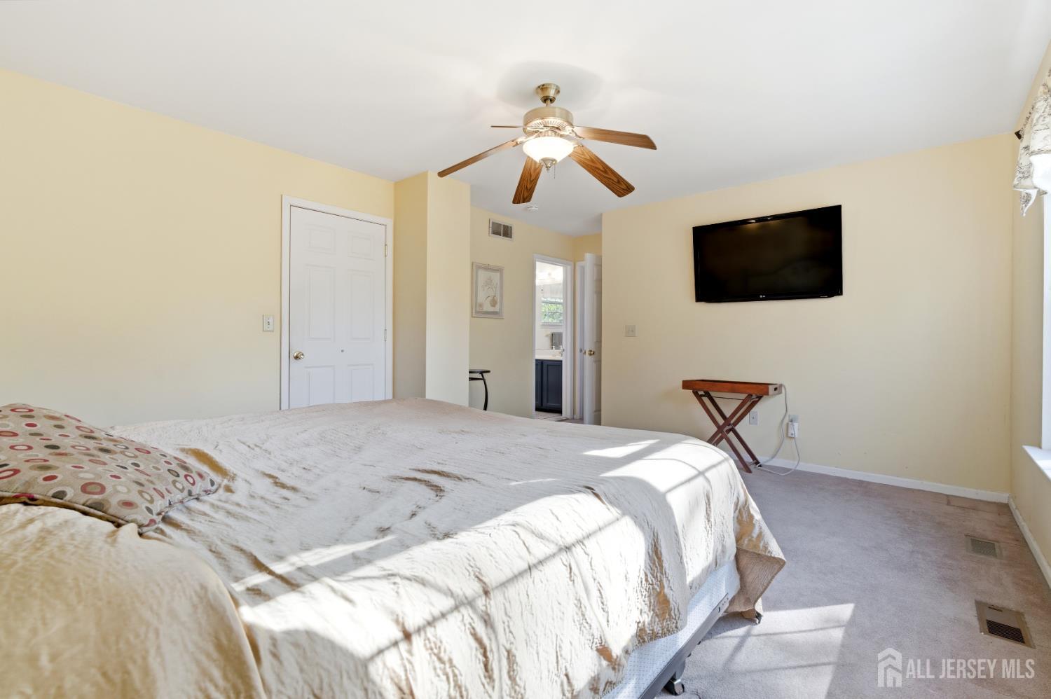 6 Shoshoni Way Somerville, NJ 08876 - Photo 32 of 52 a bedroom with a bed and a flat screen tv